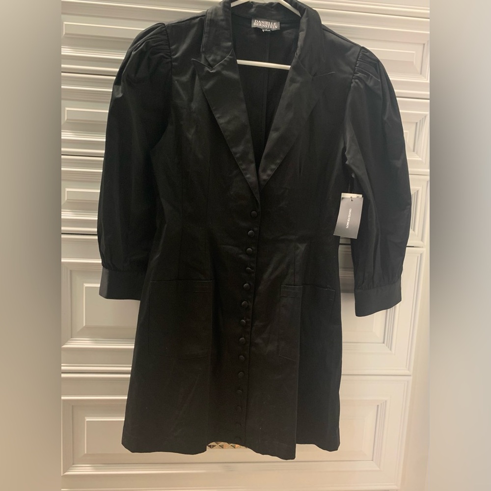 Stylish black dress with full button front and sleeves trimmed with buttons.